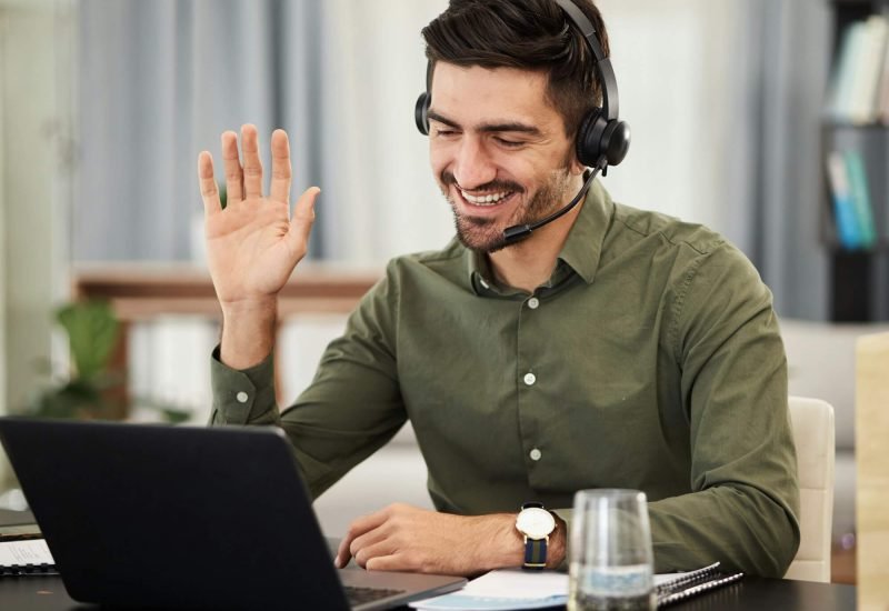 Man-Remote-Work-And-Virtual-Assistant-With-Headphones-At-Laptop-For-Video-Call-Voip-Communication-1.Jpg
